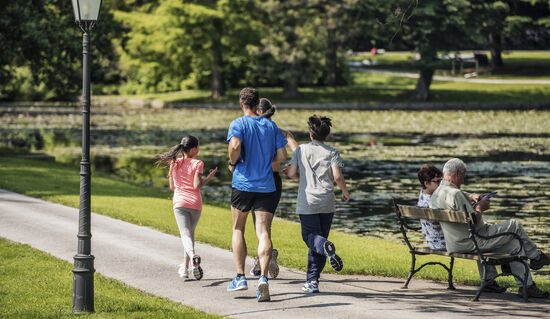 A family enjoying a morning jog together by the lake