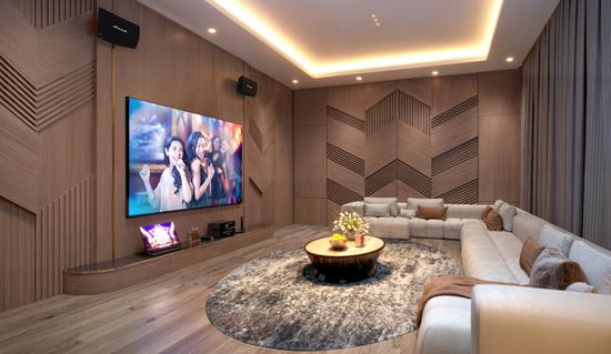 An artist’s impression of a residents’ karaoke room in the Topaz precinct at Crest@Austin, with wide plush lounges along the walls of the room facing a large television and premium sound system.